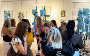 en un salòn se observa gente y cuadros